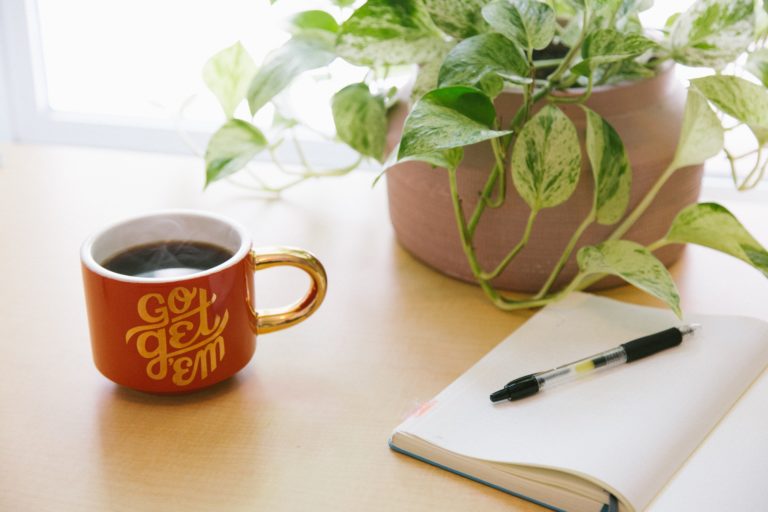 Coffee cup and notebook