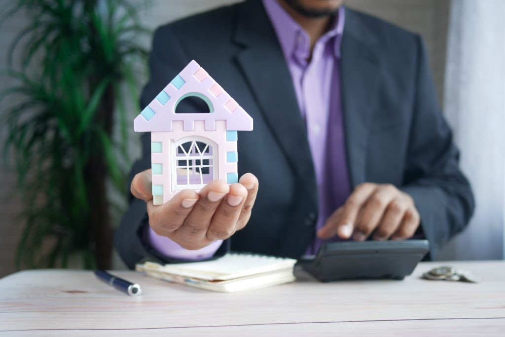 Man holding a small house